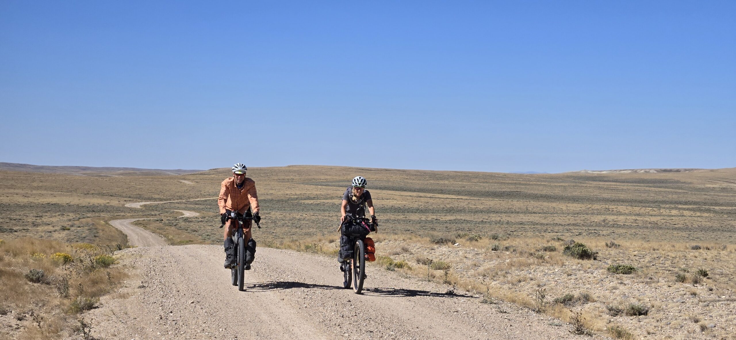 Kim and Duane on a windy road somewhere flat and barren