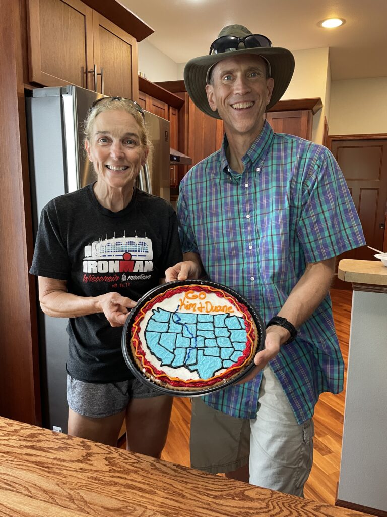 Kim and Duane (wearing a cowboy hat) and a big cookie